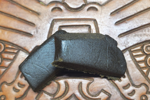 Barbol. Black polen on a textured metal surface