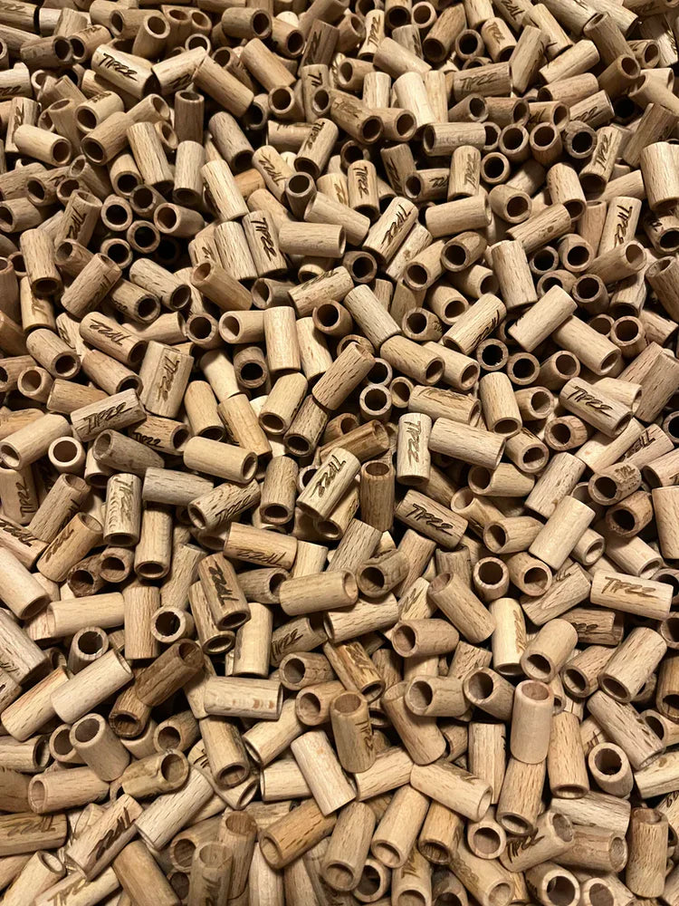 Close-up of a large pile of wooden filters with visible TIPZZ branding.
