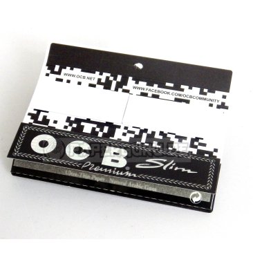 A pack of OCB King Size Slim rolling papers with OCB filter tips, featuring a black and white design with the OCB logo.